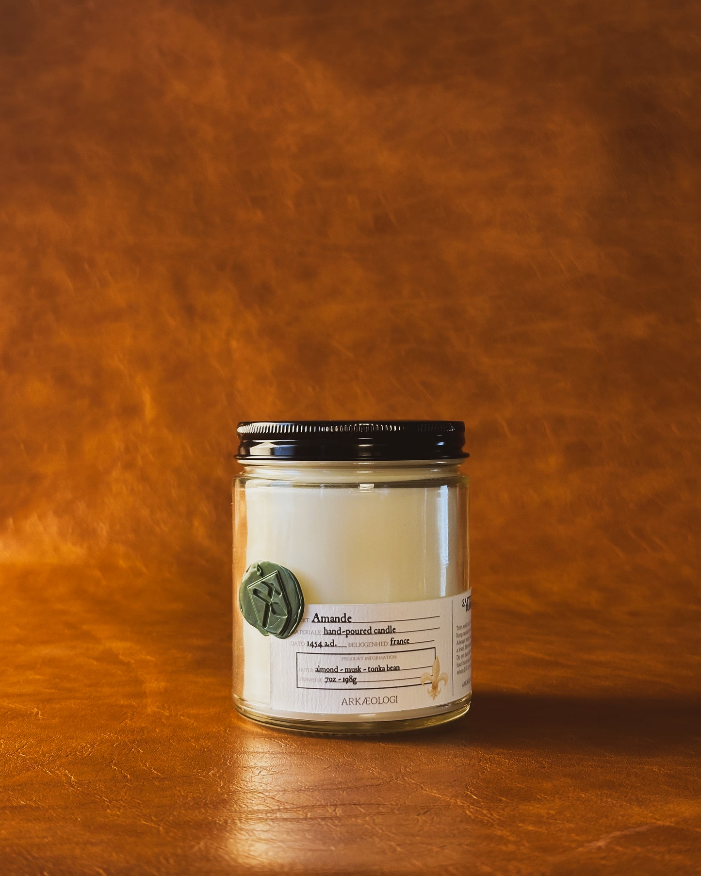 Amande candle with black lid on map background