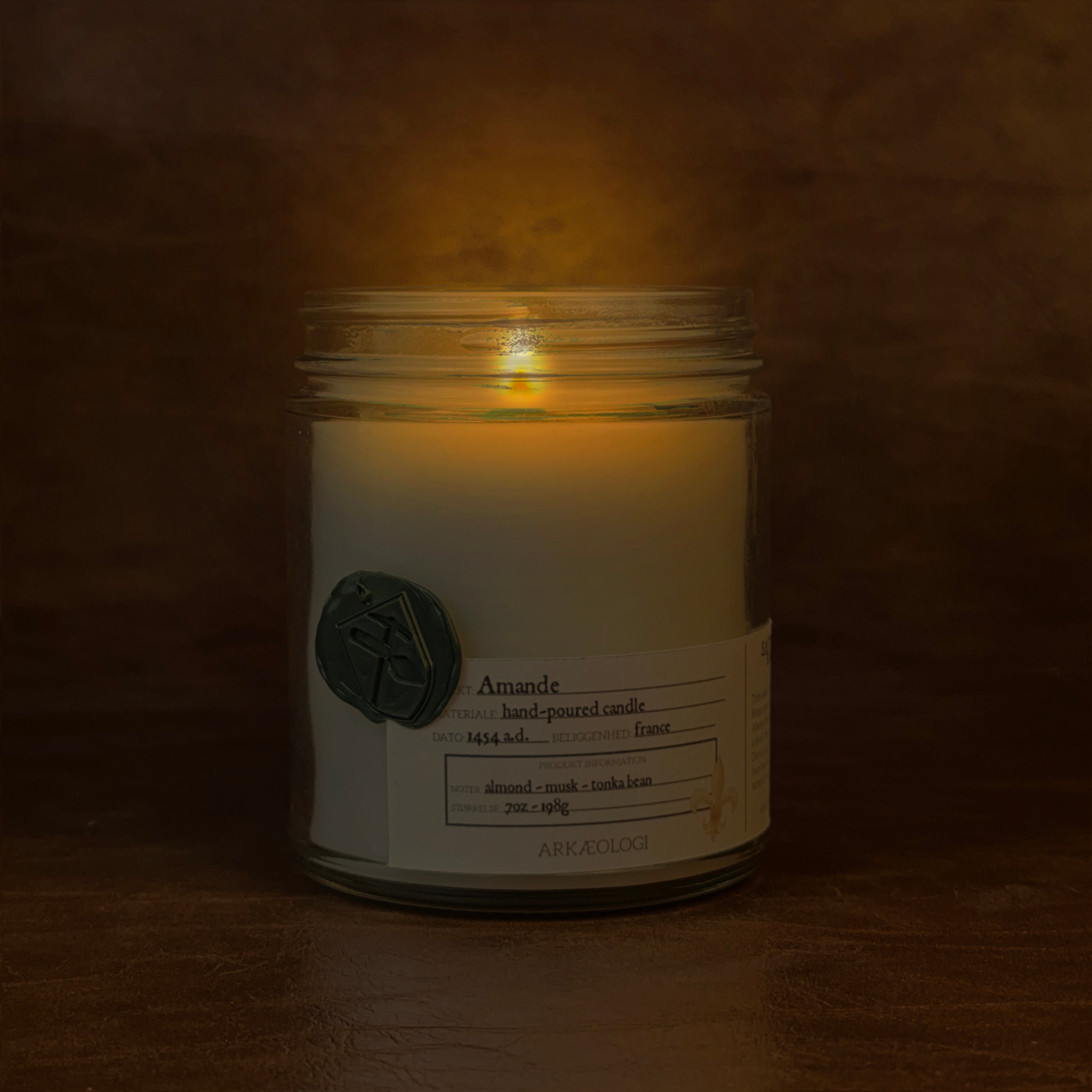 Lit Amande candle jar on map background