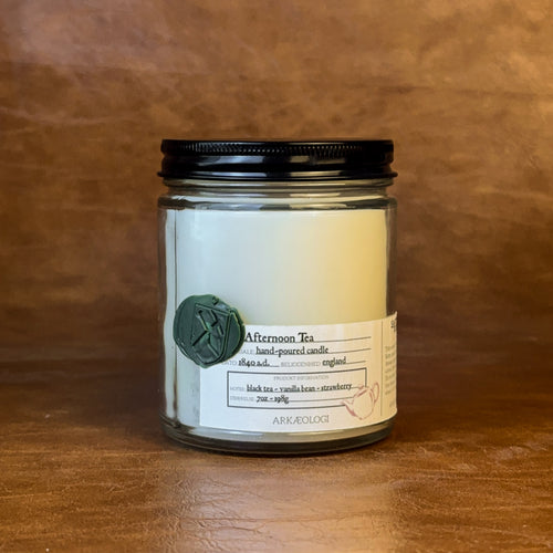 Afternoon Tea candle with black lid on map background