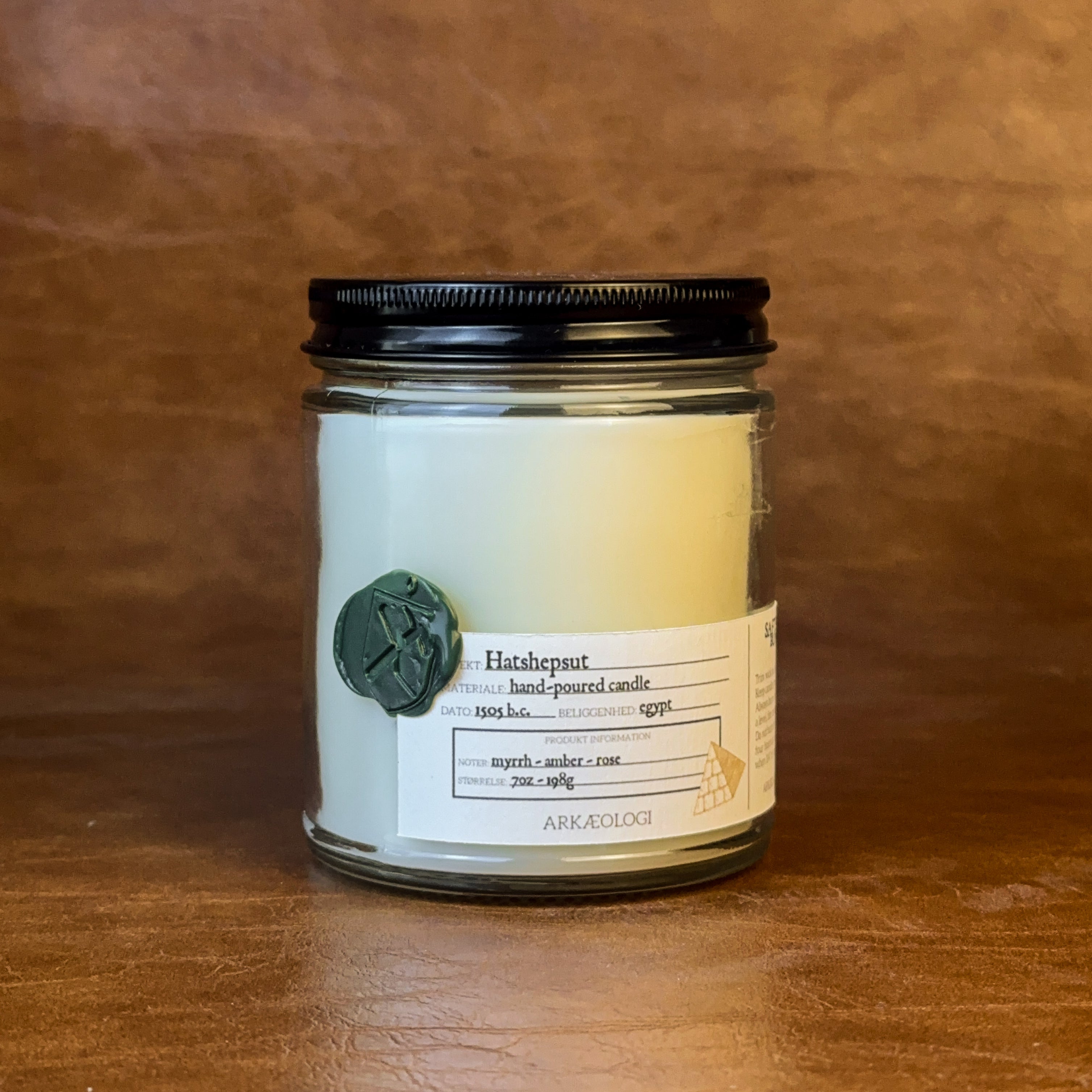 Hatshepsut candle with black lid on map background