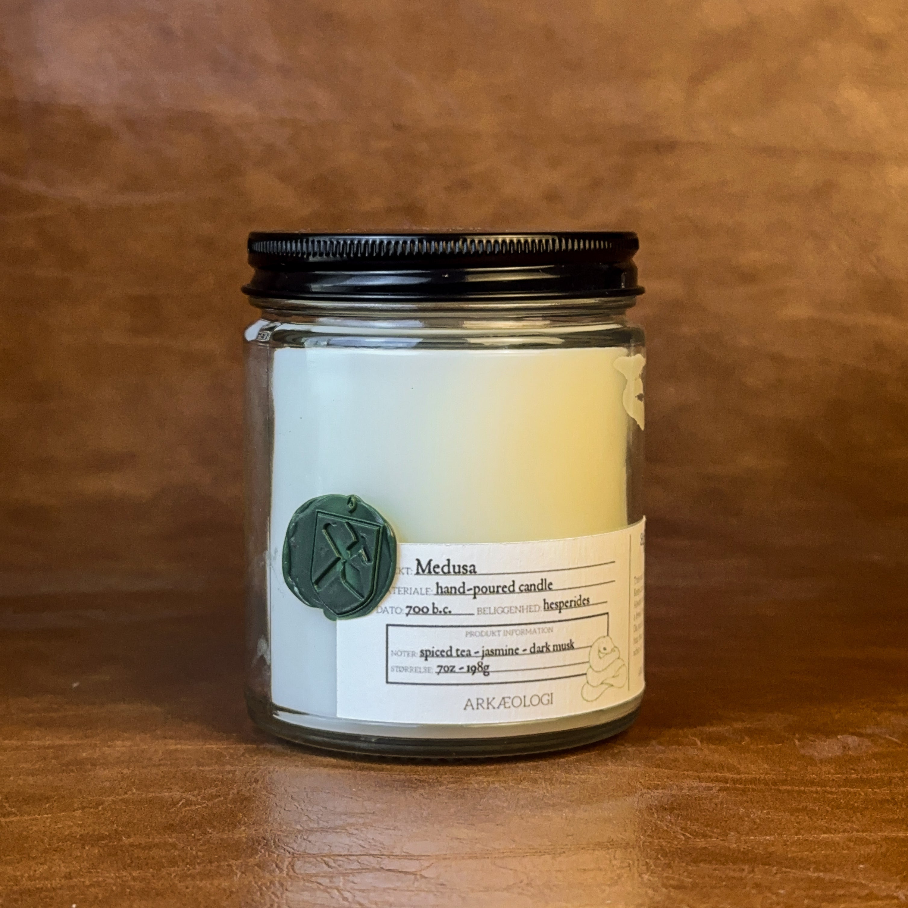 Medusa candle with black lid on map background