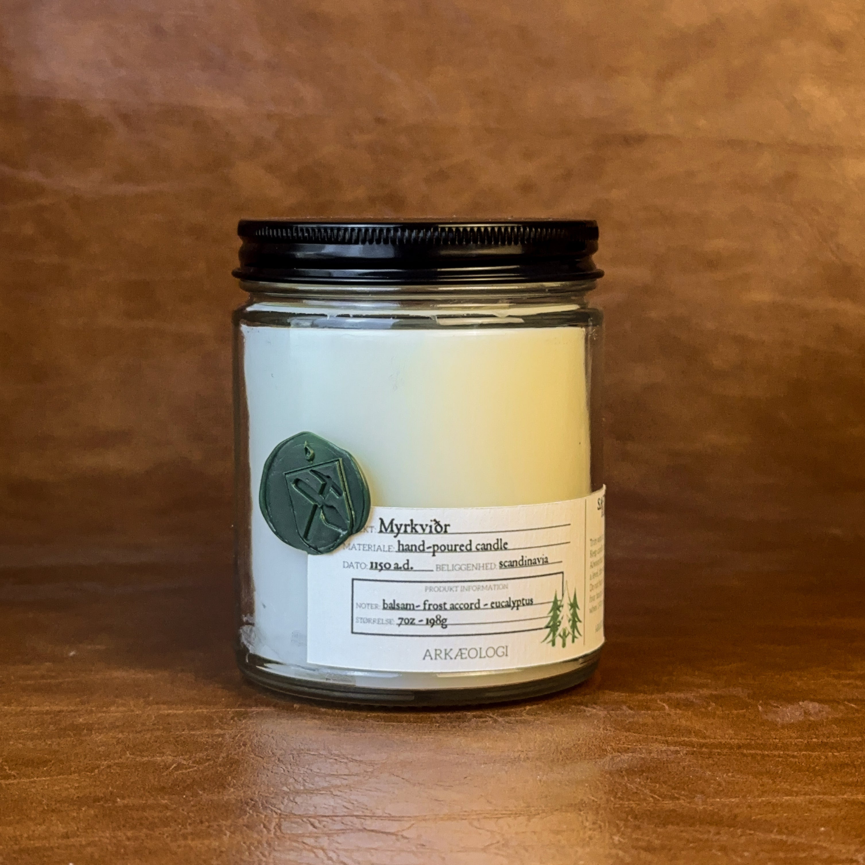 Myrkviðr candle with black lid on map background