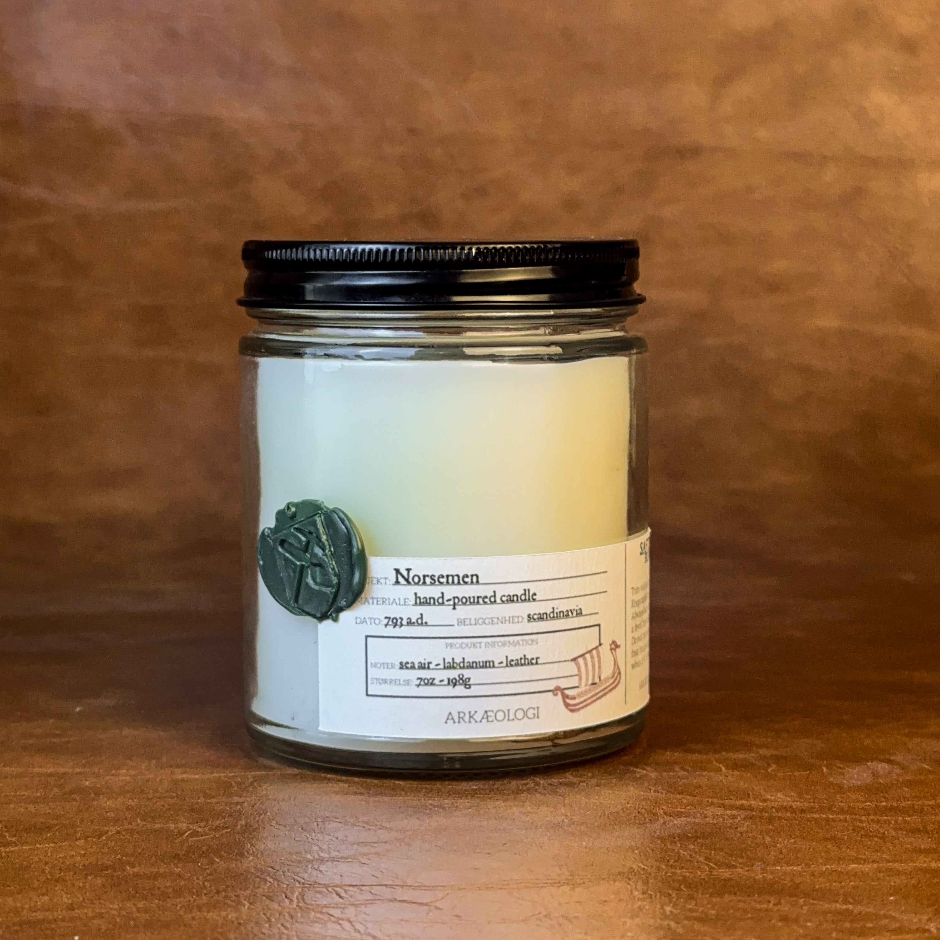 Norsemen candle with black lid on map background
