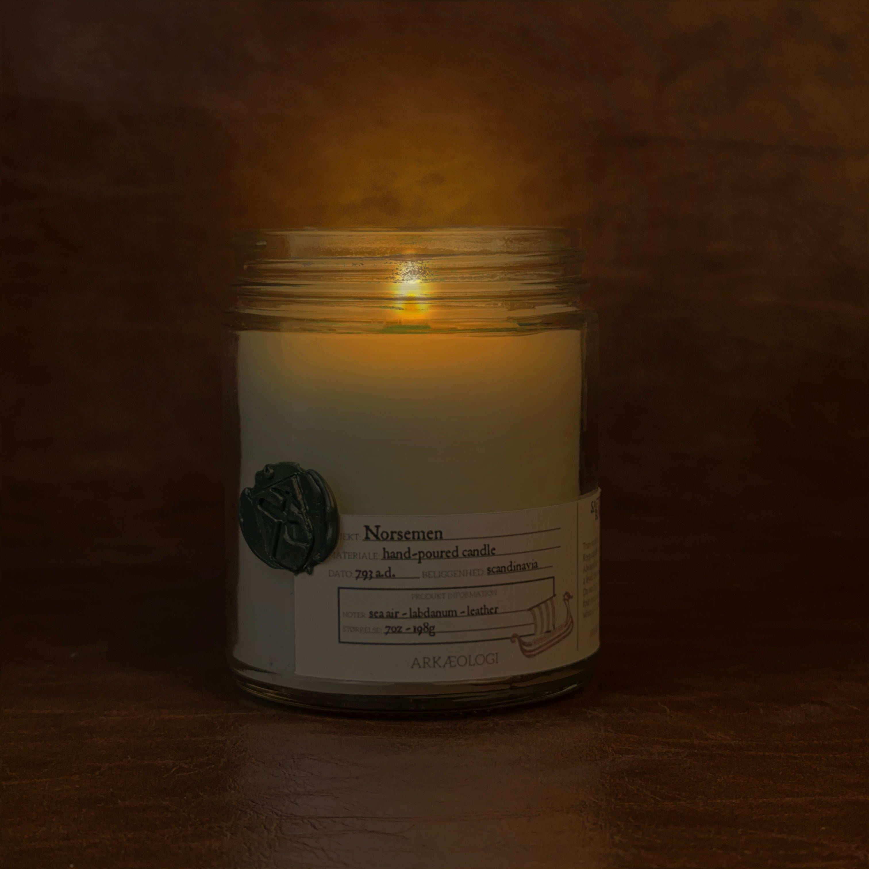 Lit Norsemen candle jar on map background