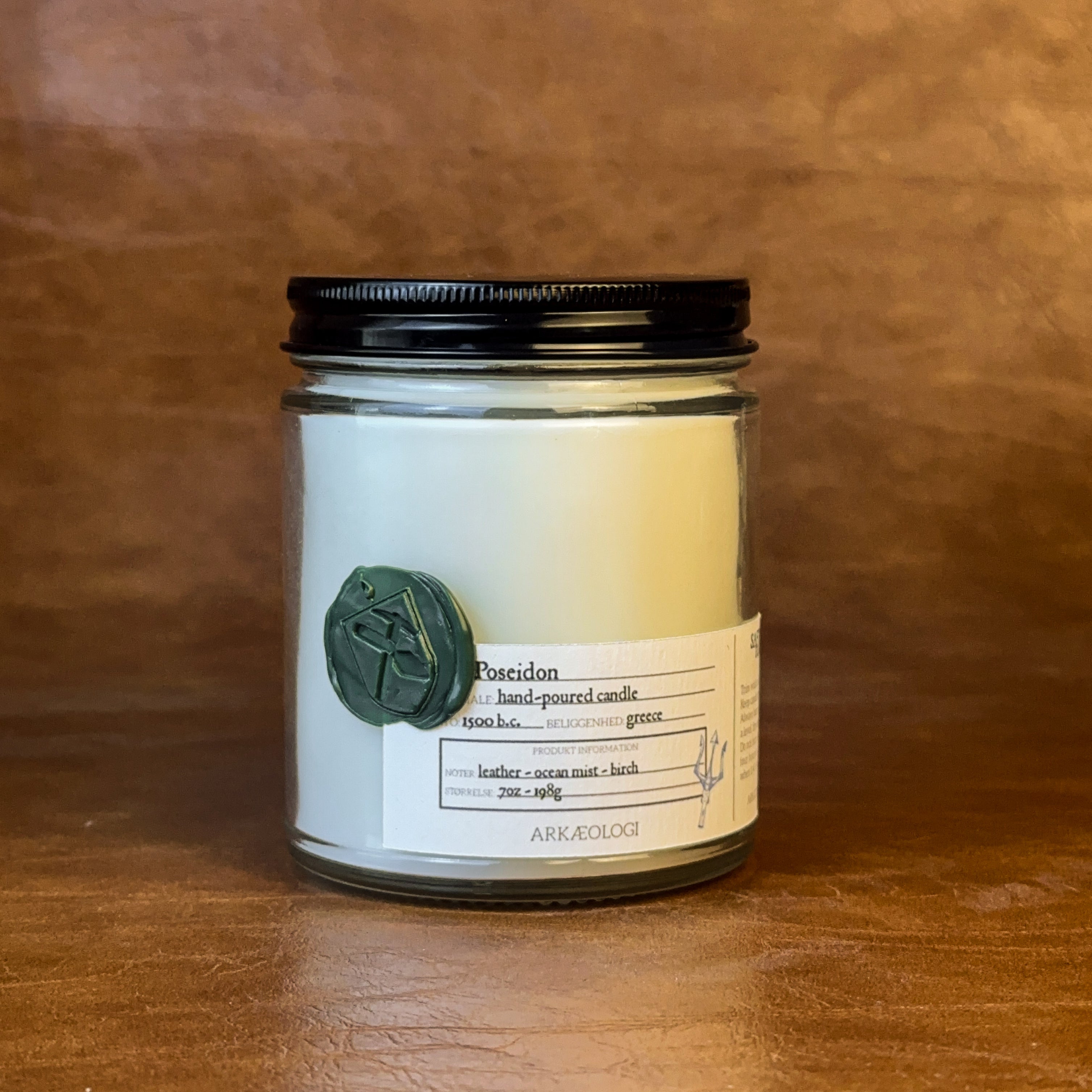 Poseidon candle with black lid on map background
