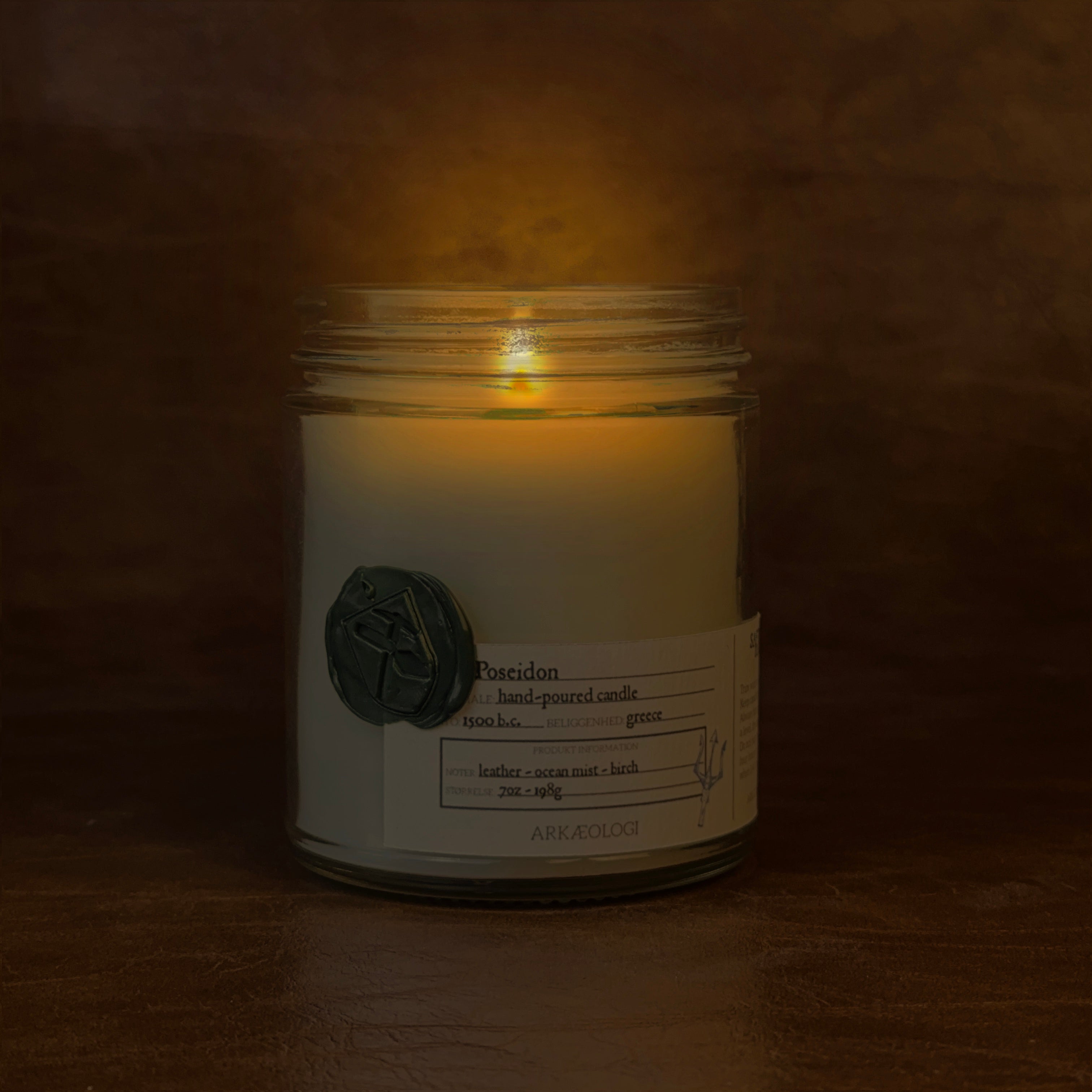 Lit Poseidon candle jar on map background