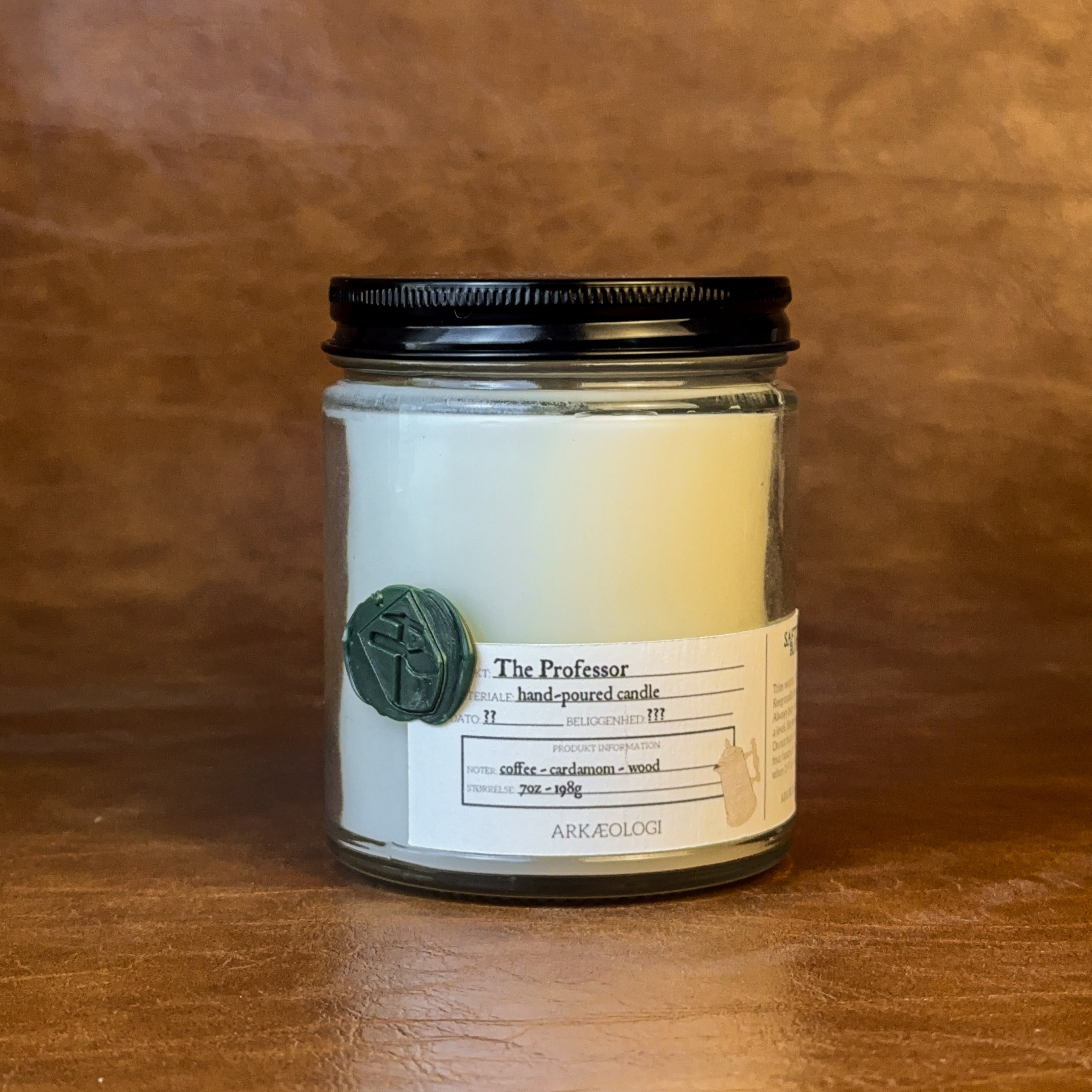 The Professor candle with black lid on map background